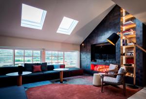 a living room with a couch and a fireplace at Ovolo Woolloomooloo in Sydney