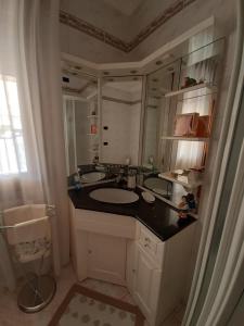 a bathroom with a sink and a large mirror at Affittacamere Da Lina in Vittorio Veneto +13 photos