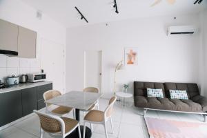 a living room with a table and a couch at NEW The Sun 3Bedrooms 10pax 2CP in Bayan Lepas