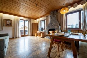 a living room with a table and a fireplace at Ciasa Cianins in San Vigilio Di Marebbe
