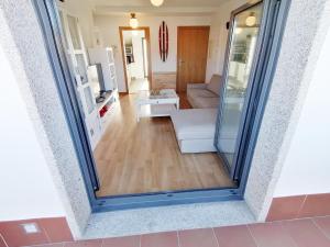 a view of a living room with a sliding glass door at O Faro in San Pedro