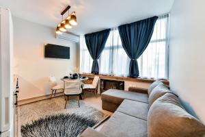 a living room with a couch and a table at Apollon Suite in Thessaloniki