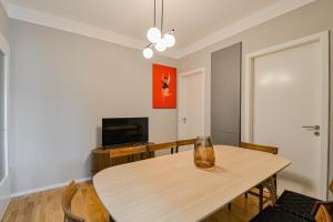 a dining room with a table and a television at Japanese Design 3BDR Apartment in a Vibrant Area in Prague