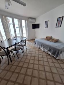 a bedroom with a bed and a table and chairs at Apartment Chunin Depart in Salta