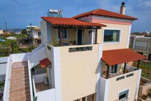 a large house with a red roof at Villa Aitheras with sea views and garden in Stérnai