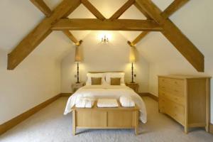 a bedroom with a large bed and a wooden dresser at Hornington Lodge in York