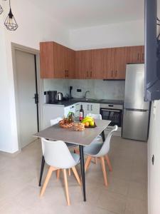 a kitchen with a table with a bowl of fruit on it at KaVros Cozy Apartment in Kavros