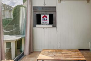 a living room with a tv on a shelf at Rietpanne Gv06 in Sint-Idesbald