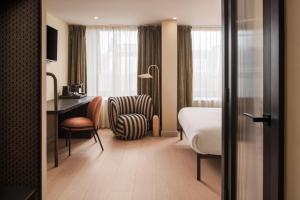 a hotel room with a bed and a desk at Central Park Hotel in London