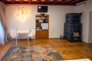 a living room with a table and a fireplace at Altius Studio in Braşov
