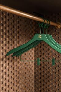 a green umbrella hanging from a baseball bat at Central Park Hotel in London +60 photos