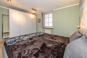Postel nebo postele na pokoji v ubytování "Vue Du Clocher" - Etroubles Boutique Apartment