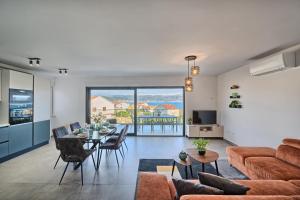 a living room with a couch and a table at The Lookout Liveli - Premium Sea-View Apartment in Slatine