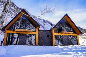 a house in the snow with snow at Cottage River Sound in Kazbegi
