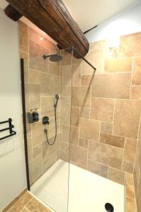 a shower with a glass door in a bathroom at Mas des Druilles in Générargues +41 photos