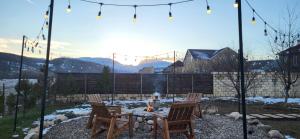 a patio with two chairs and a table with a fire at Riverside villa in Qusar +23 photos