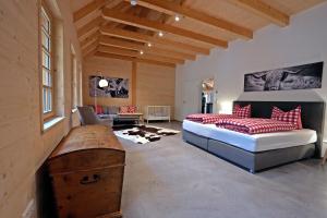 a bedroom with a bed with red pillows at Haldenhof, Design Retreat im Schwarzwald by living TIMELESS in Simonswald