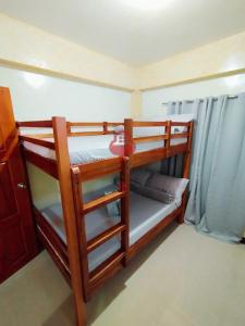 two bunk beds in a small room with at The Key Transient in La Trinidad