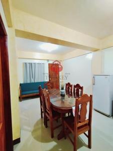 a dining room with a table and chairs and a refrigerator at The Key Transient in La Trinidad +14 photos