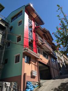 a building with colorful paint on the side of it at The Key Transient in La Trinidad