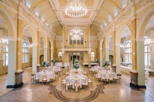 a banquet hall with white tables and chairs in a building at Wildbad Rothenburg in Rothenburg ob der Tauber