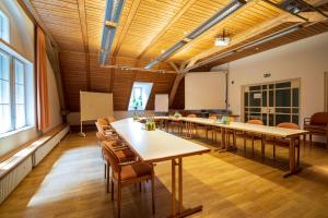 a meeting room with tables and chairs in a building at Wildbad Rothenburg in Rothenburg ob der Tauber