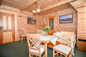 a dining room with a table and chairs at Willa Krokus in Zakopane