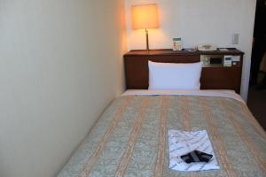 Postel nebo postele na pokoji v ubytování Ichihara Marine Hotel + 113 fotografií
