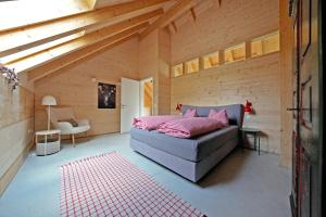 a room with a bed in a wooden house at Haldenhof, Design Retreat im Schwarzwald by living TIMELESS in Simonswald