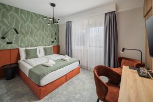A bed or beds in a room at Sziget Hotel