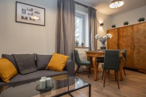 a living room with a couch and a table at Apartamenty Borek przy Modrej in Kraków
