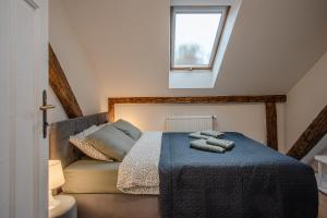 a bedroom with a bed with two towels on it at Apartamenty Borek przy Modrej in Kraków