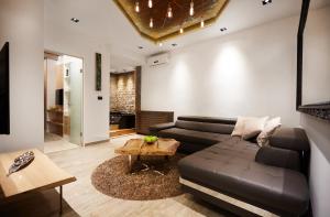 a living room with a couch and a table at One Luxury Suites in Belgrade