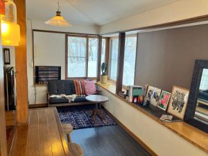 een woonkamer met een bank en een tafel bij tiny tiny Niseko in Niseko