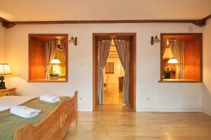 a bedroom with a large bed and two mirrors at Vincent OldTown Apartments in Wrocław