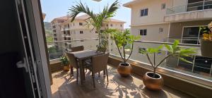 a balcony with a table and potted plants on it at Prime Line in Bortianor