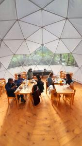 a group of people sitting at tables in a tent at FITZ CAMP - Glamping agreste - Base Cerro Fitz Roy in El Chalten