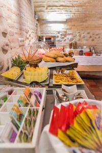 a table topped with lots of different types of food at Gar Anat Hotel Boutique in Granada