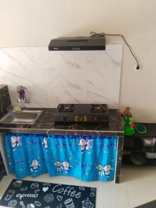 a kitchen with a stove and a counter top at Vila Alief Batu in Tlekung +13 photos