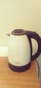 a black and white toaster sitting on a table at Habitación Amoblada in Tacna +1 photo