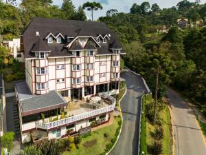 an aerial view of a large house with a road at Pousada Grandchamp - Campos do Jordao in Campos do Jordão