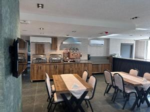 a kitchen with wooden tables and chairs in a room at Lamore Hotel in Ankara