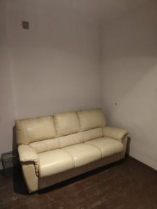 a white couch sitting in a corner of a room at Biały dom Cyprysowa 11 in Warsaw