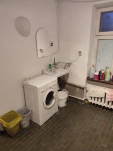 a laundry room with a washing machine and a sink at Biały dom Cyprysowa 11 in Warsaw