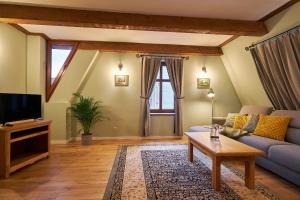 a living room with a couch and a tv at Vincent OldTown Apartments in Wrocław +42 photos