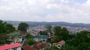 a view of a city with houses and trees at The Shillong Hills Guest House in Shillong