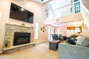 a living room with a fireplace and a tv at Home Tucked into Towamensing Trails in Albrightsville