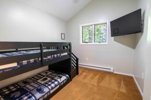 a bedroom with two bunk beds and a window at Home Tucked into Towamensing Trails in Albrightsville