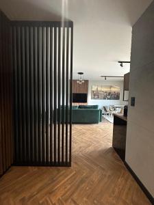 a living room with a large radiator and a kitchen at Apartament Garden in Leszno +6 photos