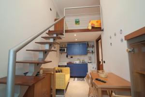 ein Wohnzimmer und eine Küche mit einer Wendeltreppe in der Unterkunft La Terra Del Sole in Neapel